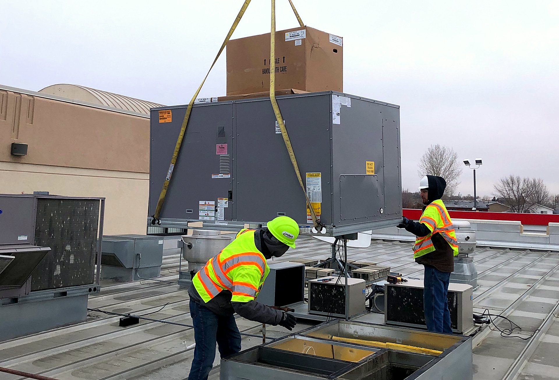 Lindtech technicians working on a rooftop unit